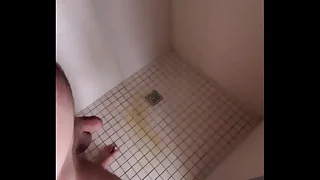 Guy pissing anent shower